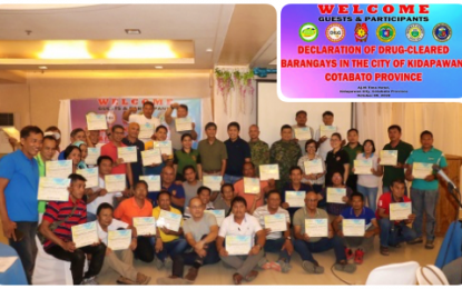 <p><strong>DRUG CLEARED.</strong> Village officials of Kidapawan City present their communities’ respective certification given by the Philippine Drug Enforcement Agency in Region 12 during a ceremony (inset) that declared their areas as drug cleared on Wednesday (Oct. 9, 2019). Kidapawan City Mayor Joseph Evangelista has recognized the active participation of the Barangay Anti-Drug Abuse Council in the city’s 40 villages for the latest achievement. <em>(Photo courtesy of Kidapawan CIO)</em></p>