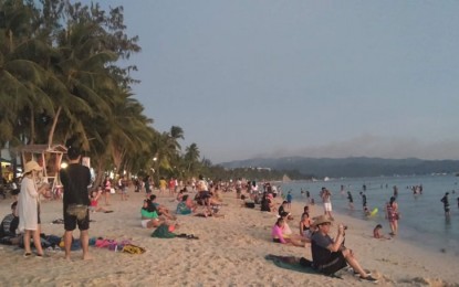 <p><strong>NEEDED BOOST. </strong>Photo shows tourists at the beachfront of Boracay Island. The local government of Malay welcomes the visit of President Rodrigo Duterte on the island to prove that the country is safe for travel amid the novel coronavirus scare. (<em>File photo</em>)  </p>