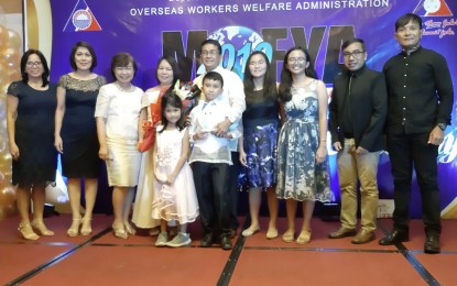 <p><strong>MODEL FAMILY</strong>. Ananias Legarde (center, in barong) poses with his family and the selection committee after receiving his Model OFW Family of the Year award (sea-based category) in a ceremony in Cebu City on Friday (Oct. 11, 2019). Legarde and the land-based category winner, Donna Ofamin, a domestic helper from Maribojoc, Bohol, will vie for the same categories at the national level. <em>(PNA photo by John Rey Saavedra)</em></p>