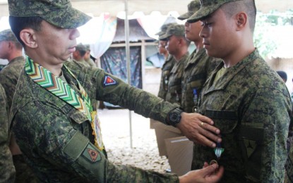 <p><strong>COMMENDATION MEDAL.</strong> Brig. Gen. Benedict Arevalo, commander of 303rd Infantry Brigade, pins a Military Commendation Medal to a trooper of the 31st Division Reconnaissance Company for demonstrating exemplary action during a clash against the communist rebels in southern Negros last week. The awarding rites were held at the 62IB headquarters in Barangay Libas, Isabela town on Monday.<em> (Photo courtesy of 303rd Infantry Brigade, Philippine Army)</em></p>