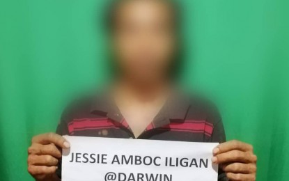 <p><strong>NEW LIFE.</strong> Former communist rebel Jessie Amboc Iligan, a resident of San Miguel, Surigao del Sur, yields along with another colleague to the Army's 36th IB on October 11, 2019. Iligan says he wants to start a new life with his family. <em>(Photo courtesy of the Army's 36th IB)</em></p>