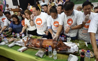 <p><strong>LECHON FESTIVAL VS. ASF.</strong> Pampanga Governor Dennis Pineda, other local chief executives and hog industry stakeholders feast on "lechon," "tocino," and "sisig" during the Pork and Meat Festival held in the City of San Fernando, Pampanga on Tuesday (Oct. 15, 2019). Themed “Karneng Baboy sa Pampanga Ligtas, Kumain at Mag-enjoy," the activity aimed to assure the public that pork and other meat products from Pampanga are safe to eat amid concerns on African swine fever.<em> (Photo by Marna Del Rosario)</em></p>