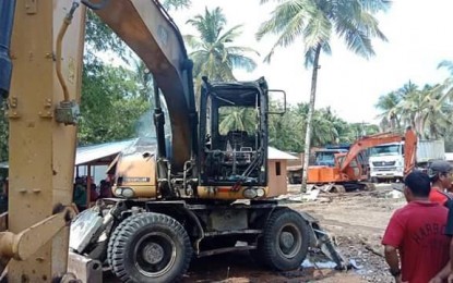<p><strong>NPA ATROCITY.</strong> A backhoe loader is severely damaged after armed men believed to be members of the New People's Army attacked the stocking area of a construction firm in Barangay Campo, Bacuag, Surigao del Norte on Monday (Oct. 14, 2019). <em>(Photo courtesy of the Army's 30th IB)</em></p>