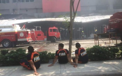 <p><span lang="EN-US"><strong>FIRE OUT.</strong> Firefighters of the Bureau of Fire Protection take a break after battling the fire at the Gaisano Mall in General Santos City for more than 16 hours. Firefighters officially declared “fire out” at the establishment at about 1 p.m. Thursday (Oct. 17, 2019). <em>(PNA photo by Richelyn Gubalani)</em></span></p>