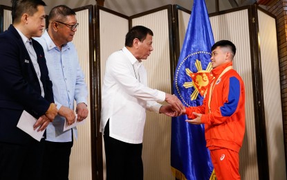 <p><strong>INCENTIVES.</strong> President Rodrigo Roa Duterte meets 49th FIG Artistic Gymnastics World Championships gold medalist Carlos Yulo at the Malago Clubhouse in Malacañang on Oct. 16, 2019. The Philippine Sports Commission on Tuesday (Oct. 26, 2021) approved the granting of PHP750,000 worth of special incentives for Carlos Edriel Yulo for his double-medal performance at the 2021 World Artistic Gymnastics Championships in Japan.<em> (Presidential photo)</em></p>