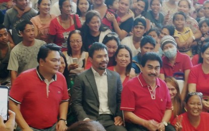 <p><strong>ADOPTED SON.</strong> Senator Emmanuel 'Manny' Pacquiao (seated, center), with Mayor Evelio Leonardia (right) and Lone District Rep. Greg Gasataya (left), met with hundreds of Bacolodnons at the Bacolod City Government Center lobby on Thursday afternoon (Oct. 17, 2019). Before he left, Pacquiao gave out balato (cash gifts) of PHP1,000 each to some 4,000 people who came to see him. <em>(PNA photo by Nanette L. Guadalquiver)</em></p>