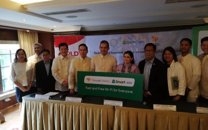 <p><strong>FREE WI-FI FOR TOURISTS.</strong> Officials of the Department of Tourism, PLDT and Smart pose for a photo opportunity shortly after the signing of a memorandum of agreement for the installation of free Wi-Fi stations in Intramuros and Rizal Park at the Manila Hotel on Friday (Oct. 18, 2019). Tourism Secretary Bernadette Romulo-Puyat (5th from right) said the provision of free Wi-Fi in tourist hotspots encourages the natural promotion of Philippine tourism through social media. <em>(PNA photo by Raymond Carl Dela Cruz)</em></p>