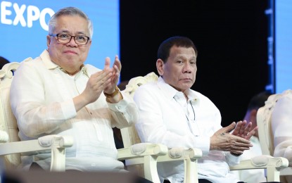 <p>President Rodrigo Duterte (right) and Trade Secretary Ramon Lopez <em>(File photo)</em></p>