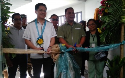 <p><strong>GROWTH DRIVER.</strong> Cabinet Secretary Karlo Alexei Nograles (second from left), Ricardo Visaya (second from right), chief of the National Irrigation Administration; and Rosalinda Bote (rightmost), department manager of the Upper Pampanga River Integrated Irrigation System (UPRIIS), cut the ceremonial ribbon that formally opens the Pantabangan Lake Resort Hotel in Barangay Fatima, Pantabangan, Nueva Ecija on Thursday (Oct. 17, 2019). The facility is expected to further spur tourism and economic growth in Central Luzon. <em>(Photo by Marilyn Galang)</em></p>