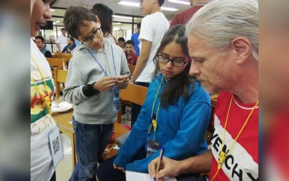 <p><strong>HACKATHON.</strong> Nine-year-old Allen Blauuw (2nd from left) participates in a team activity during the National Aeronautics and Space Administration (NASA) Space Apps Challenge at the Central Philippine University (CPU) on Friday (Oct. 18, 2019). Iloilo was one of the locations of the NASA-led international hackathon, which provided participants NASA data to develop solutions for real-world challenges. <em>(PNA photo by Gail Momblan)</em></p>