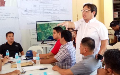 <p><strong>ASSESSMENT.</strong> Members of the Digos City Disaster Risk Reduction and Management Council tackle various issues surrounding the damage brought by the 6.3 magnitude earthquake that hit the area on October 16. City Councilor Marc Fernandez (standing, top photo), Mayor Josef Cagas (extreme right), discuss a point with Vice-Mayor Johari Baña (facing back from the camera) on how to mitigate the damage brought by the earthquake. <em>(PNA photo by Eldie S. Aguirre)</em></p>