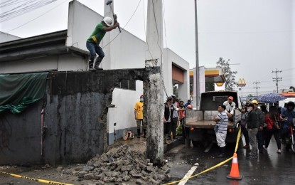 <p><strong>ROAD CLEARING.</strong> A wall built on the sidewalk is demolished in La Trinidad, Benguet. Three LGUs in the Cordillera Administrative Region failed the road clearing assessment of the Department of the Interior and Local Government. <em>(Photo courtesy of Redjie Melvic Cawis/ PIA-CAR)</em></p>