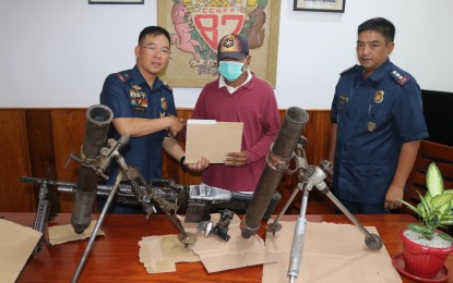 <p><strong>HIGH-POWERED FIREARMS</strong>. “Ka Diwa” (center), a platoon leader of the New People's Army group in Kalinga province surrenders to the government through Police Cordillera director Brig. Gen. Israel Ephraim Dickson (left) on October 16, bringing with him several high-powered firearms. Also in the photo is Col. Rene Pasiwen of the regional intelligence branch. <em>(Photo courtesy of PROCOR PIO)</em></p>