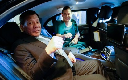 <p><strong>IN GOOD CONDITION.</strong> President Rodrigo Roa Duterte strikes his signature pose with his daughter, Davao City Mayor Sara Duterte-Carpio, as they prepare to head to the Imperial Palace in Tokyo, Japan for the Ceremonies of the Accession to the Throne of His Majesty Emperor Naruhito on October 22, 2019. Senator Christopher Lawrence ‘Bong’ Go assured that Duterte is still in good condition despite ‘unbearable’ back pain that prompted the President to cut short his Japan trip. <em>(Presidential photo)</em></p>