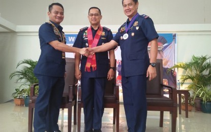 <p><strong>CHANGING OF THE GUARDS.</strong> Newly designated Acting Director of Police Regional Office 11, Brig. Gen. Filmore Escobal (left), formally accepts the position from  Brig. Gen. Marcelo Morales (right) at Camp Quintin Merecido, Davao City on Tuesday (Oct. 22, 2019). Lt. Gen. Archie Gamboa, the officer-in-charge of the Philippine National Police (center) facilitated the turnover ceremony. <em>(PNA photo by Rhoda Grace Saron)</em></p>
