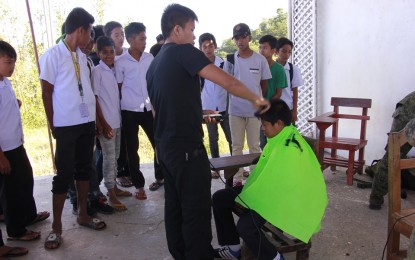 <p><strong>GOV’T SERVICES AVAILABLE.</strong> A member of the Philippine Army gives free haircut during the provincial government-led activity in Barangay Tubudan, San Remigio in 2018. On Oct. 24-25, 2019, various services will also be made available during the first provincial medical-dental mission and info caravan in Antique's two towns, organized by the Provincial Task Force to End Local Communist Armed Conflict. <em>(Photo courtesy of Margie Gadian)</em></p>