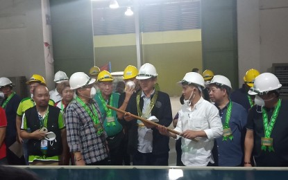<p><strong>ENGINEERED BAMBOO FACTORY.</strong> Department of Environment and Natural Resources Secretary Roy Cimatu (fourth from right) visits the engineered bamboo factory in Bayambang town, Pangasinan on Wednesday (Oct. 23, 2019). Seeing the potential of bamboo as replacement for wood and its high survival rate, Cimatu plans to increase bamboo plantation from 20 percent to 40 to 45 percent under the National Greening Program. <em>(Photo by Hilda Austria)</em></p>