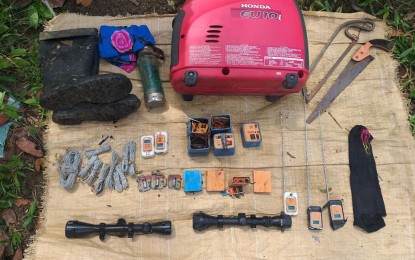 <p><strong>RECOVERED.</strong> Shown in photo are items recovered by government troops including parts for making improvised explosives or landmine, a power generator, rifle scopes, among others, from an abandoned encampment of the New People's Army rebels in Barangay Mabato, Ayungon, Negros Oriental on Wednesday, (Oct. 23, 2019). Civilians reported the presence of armed men in the area, about a kilometer away from where four policemen were killed by rebels last July. <em>(Photo courtesy of Army's 303rd Infantry Brigade)</em></p>