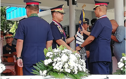 <p><strong>NEW CALABARZON TOP COP.</strong> Philippine National Police (PNP) Chief Officer-In-Charge (OIC), Lt. Gen. Archie Francisco F. Gamboa (center) turns over the symbolic regional command flag to incoming Police Regional Office 4-A (Calabarzon) director, Brig. Gen. Vicente D. Danao Jr. (right) in a ceremony held at the Camp Gen. Vicente Lim, Calamba City, Laguna on Wednesday (Oct. 23, 2019). Danao replaces Brig. Gen. Edward Carranza, who was designated as new director of the PNP Logistics Support Service. <em>(PNA photo by Saul E. Pa-a)</em></p>