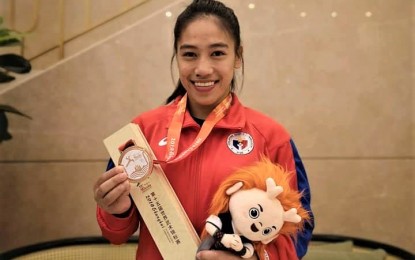 <p><strong>DIVINE BRONZE</strong>. Divine Wally poses with her medal after finishing third in the World Wushu Championship this week. The Philippine team had a two-two silver-bronze medal haul and finished 15th in the 37 nation competition. <em>(PNA photo courtesy of Divine Wally’s FB)</em></p>