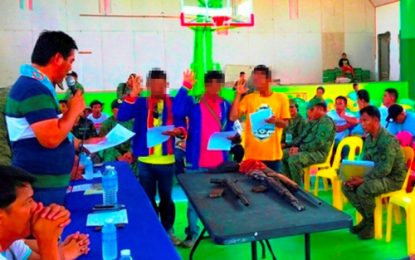 <p><strong>SURRENDERERS.</strong> Communist rebels who surrendered to the Army's 37th Infantry Battalion in Palimbang, Sultan Kudarat take their oath of allegiance to the government before the town's local officials on Oct. 20, 2019. The surrenderers led government troops to overrun on Friday (Oct. 25, 2019) a major hideout of New People’s Army rebels in the mountains of Palimbang. <em>(Photo courtesy of 37th IB)</em></p>