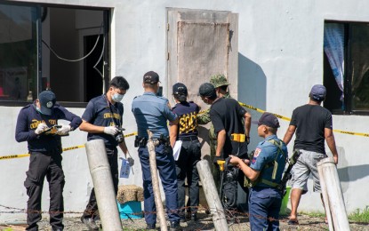 <p><strong>POLICE STATION BLAST.</strong> Police personnel inspect the damage following the blast that occurred at the police headquarters of Quezon town in Bukidnon on Thursday night (October 24). Police blamed the communist rebels for the explosion that damaged the roof of the building and a civilian vehicle. <em>(Contributed photo)</em></p>