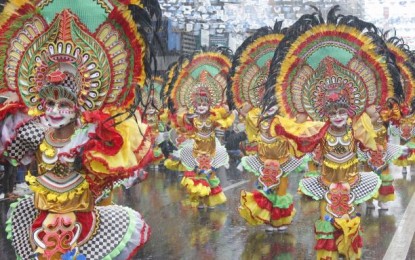 <p><strong>STREET PERFORMANCE</strong>. Performers of Barangay Estefania, the grand champion in the street and arena dance competition, during the 2019 MassKara Festival in Bacolod City. The festival is returning after two years of hiatus due to the pandemic.<em> (File photo courtesy of Bacolod City PIO)</em></p>