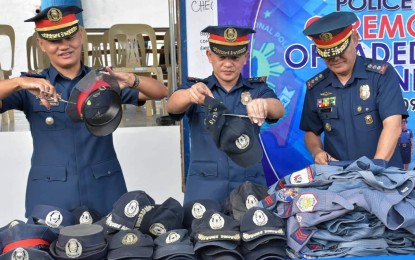 <p><strong>OLD UNIFORMS.</strong> Officials of the Police Regional Office in Western Visayas led by (left to right) Lt. Col. Columbo Allan Aberia, officer-in-charge, Regional Anti-Cyber Crime Unit; Lt. Col. Lavis Camdas, officer-in-charge, Regional Learning and Doctrine Development Division; and Col. Remus Zacharias Canieso, Deputy Regional Director for Administration; spearhead the disposal of 221 old, faded, and worn-out uniforms of police personnel at Camp Delgado in Iloilo City on Monday (Oct. 28, 2019). The move was done in adherence to the Philippine National Police's “Tamang Bihis Alpha” in line with its internal cleansing program. <em>(Photo courtesy of PRO-6 PIO)</em></p>