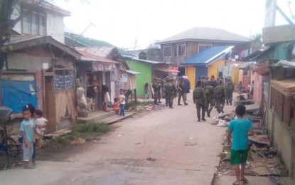 <p><strong>SPREADING PANIC</strong>. Children curiously watch the soldiers and police on foot patrol in Sitio Buggoc, Barangay Sta. Catalina on Wednesday (Oct. 30, 2019) following the reported presence of MNLF members in the barangay. (<em>Photo courtesy: Remus L. Ong</em>)</p>