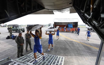 <p><strong>RELIEF FOR QUAKE VICTIMS. </strong>PAF personnel carry relief goods and other items for earthquake victims which were airlifted to General Santos City on Wednesday (Oct. 30, 2019). These include 500 family food packs, 500 sleeping kits, 500 laminating sacks, and 50 family tents from the Department of Social Welfare and Development. <em>(Photo courtesy of PAF Public Affairs Office)</em></p>