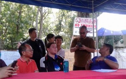 <p><strong>QUAKE AREA VISIT</strong>. Davao City Mayor Sara Duterte (seated middle) listens as Mayor Russel Abonado (right) and Vice Mayor Lito Piñol (left) of Mlang, North Cotabato update her on the extent of damage brought about by the series of quakes that rocked the province, during her visit on Friday (Nov. 1, 2919). <em>(PNA photo by Edwin Fernandez)</em></p>