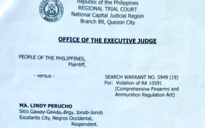 <p><strong>WARRANT.</strong> The search warrant, dated Oct. 30, 2019, issued against one of two persons believed to have links to the Communist Party of the Philippines - New People’s Army. Two were arrested with firearms and ammunition in separate military operations in Escalante City, Negros Occidental on Friday morning (Nov. 2, 2019).<em> (PNA photo by Nanette Guadalquiver)</em></p>