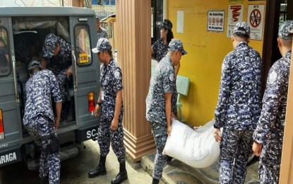 <p><strong>RICE FROM INMATES.</strong> Personnel from the Surigao City Jail load 30 sacks of rice for delivery to the earthquake-affected areas in Mindanao. The sacks of rice were voluntarily donated by the inmates by cutting their regular ration for one day. <em>(Photo courtesy of Surigao City Jail Information Office)</em></p>