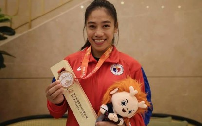 <p><strong>BRONZE IT IS.</strong> Divine Wally with her bronze medal in the World Wushu Championships held in Shanghai, China last October 19-24, 2019. Wally and the Wushu Sanda team arrive today in Manila after their four months training in China. <em>(Photo from www.olympic.ph)</em></p>