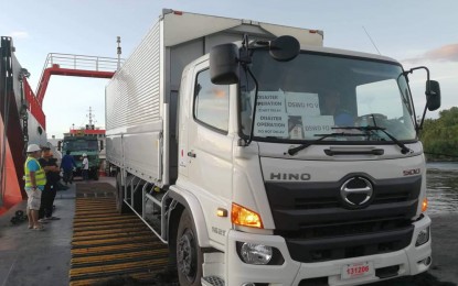 <p><strong>OFF TO MINDANAO</strong>. Truckloads of relief materials are being loaded for shipping from Legazpi City to quake-hit areas in Mindanao on Sunday (Nov. 3, 2019). The non-food items from the DSWD-Bicol are worth a little over PHP12 million. <em>(Photo courtesy of DSWD-Bicol)</em></p>