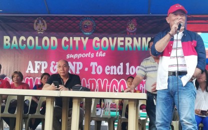 <p><strong>SUPPORT.</strong> Valladolid town Mayor Enrique Miravalles, president of the League of Municipalities of the Philippines - Negros Occidental, speaks before a gathering for peace in Bacolod City led by Vice Mayor El Cid Familiaran (seated) on Monday afternoon (Nov. 4, 2019). The activity expressed support for the Armed Forces of the Philippines and the Philippine National Police in the campaign to end the local communist armed conflict. <em>(PNA photo by Nanette L. Guadalquiver)</em></p>