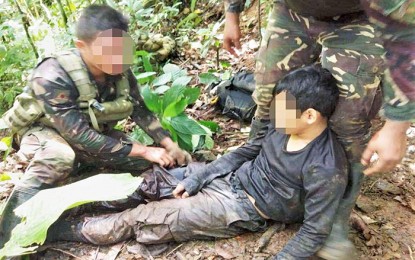 <p><strong>DECEIVED.</strong> Alias Kent, 19, is provided with first aid by government soldiers after being abandoned by his New People's Army colleagues following an encounter in Santiago town, Agusan del Norte Saturday (Nov. 2, 2019)). Kent said he was only 17 when the communist rebels recruited him. <em>(Photo courtesy of Army’s 29IB)</em></p>