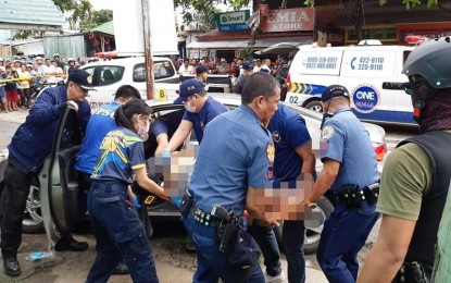 <p><strong>SLAIN.</strong> The bullet-riddled body of radio blocktimer Dindo Generoso is being pulled out of his car after he was gunned down in Barangay Piapi, Dumaguete City early Thursday morning (Nov. 7, 2019). Generoso was headed to the DYEM-FM Bai Radio 96.7 station for his early morning program when two motorcycle-riding suspects shot him. <em>(Photo by Juancho Gallarde)</em></p>