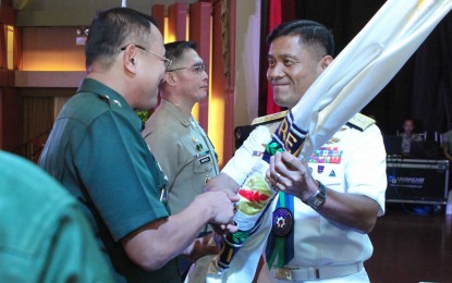 <p><strong>NEW CRSAFP CHIEF.</strong> Armed Forces of the Philippines (AFP) Vice Chief of Staff, Vice Admiral Gaudencio Collado Jr. (right) hands over the flag of the Civil Relations Service AFP to Brig. Gen. Ernesto Torres Jr. in a change of command ceremony in Camp Aguinaldo on Wednesday (Nov. 6, 2019). Torres replaces Brig. Gen. Edgard Arevalo, AFP spokesperson and assistant deputy chief of staff for Civil-Military Operations, who served as CRSAFP's acting commander. <em>(Photo courtesy of AFP Public Affairs Office)</em></p>