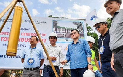 <p><strong>UPGRADED HOUSING PROJECT.</strong> National Housing Authority (NHA) head for operations Victor C. Balba (from left), Leyte Governor Mic Petilla, Senator Bong Go, NHA General Manager Marcelino P. Escalada Jr., and Tanauan Mayor Pel Tecson lead the groundbreaking and capsule-laying ceremony for the construction of the Primetown Housing 4 intended for survivors of Typhoon Yolanda in Maribi, Tanauan, Leyte. The PHP200-million resettlement project is dubbed the 'New Yolanda Project' due to its upgraded standard design.<em> (Photo courtesy of NHA)</em></p>