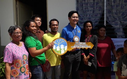 <p><strong>COMPLETED HOUSES.</strong> Cabinet Secretary Karlo Nograles turns over a symbolic key to a family in Guiuan, Eastern Samar on Saturday (Nov. 9, 2019). The Cabinet official led the turn-over of housing projects for recipients in 17 sites in the towns of Guiuan, Mercedes, Hernani, Balangiga, and Llorente in Eastern Samar, and in Marabut, Basey, Zumarraga, and Sta Rita in Samar. <em>(Photo from FB page of Secretary Nograles)</em></p>