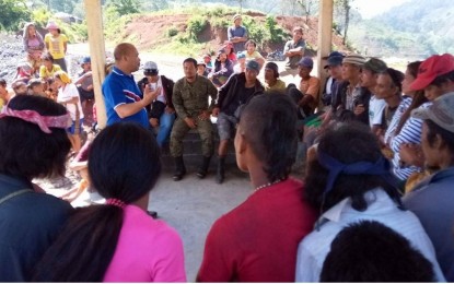 <p><strong>COMMUNITY DIALOGUE. </strong>Mayor Reynante Inocando of Cabanglasan, Bukidnon (standing, center) holds a dialogue with villagers and their children in Sitio Calapacan, Barangay Canangaan on Sunday (Nov. 10, 2019). The mayor reminded his constituents of the importance of education in keeping their children away from possible recruitment of communist rebels.<em> (Photo courtesy of the Army's 8th Infantry Battalion)</em></p>