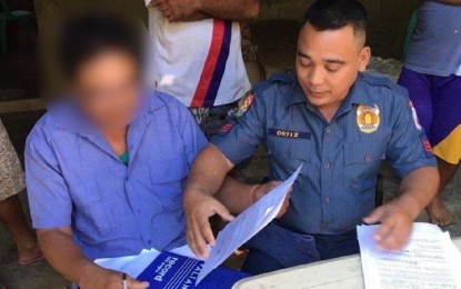 <p><strong>ARRESTED. </strong> Herman Alliza (left) 55, a suspected local leader of the Communist Party of the Philippines-New People’s Army (CPP-NPA), is arrested by the Maasin police on Sunday (Nov. 11, 2019) at his house in Bolo village. Police investigation showed he had served as a liaison officer between the rebels and politicians. <em>(Photo courtesy of 1st Iloilo Mobile Force Company)</em></p>