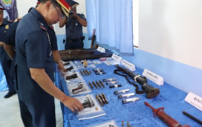 <p><strong>ONE TIME, BIG TIME.</strong> Brig. Gen. Alfred Corpus (left), director of the Police Regional Office (PRO-12), inspects the assorted firearms and other illegal items seized during a series of operations in parts of Region 12 or Soccsksargen on Monday (Nov. 11, 2019). A suspect in the killing of a town councilor in Maitum, Sarangani province was killed while 35 wanted persons and drug personalities were arrested during the raids. <em>(Photo courtesy of PRO-12)</em></p>