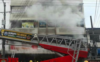 <p><strong>TRAGEDY</strong>. Firefighters put out the blaze engulfing a building that houses an automotive store in Olongapo City on Wednesday (Nov. 13, 2019). A married couple and their two-year-old son died in the early morning fire. <em>(Photo by Mahatma Datu)</em></p>