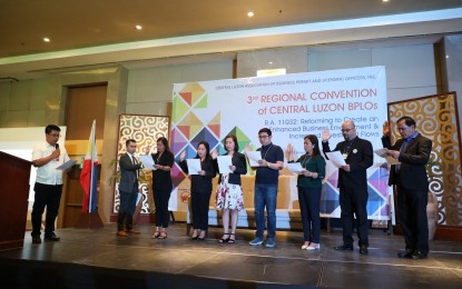 <p><strong>EASE OF DOING BUSINESS.</strong> Jay E. Timbreza (left), assistant regional director of the Department of the Interior and Local Government-Region 3 leads the induction of the newly-elected Central Luzon Association of Business Permit and Licensing Officers, Inc. (CLAB) officers during the 3rd Regional Convention of CLAB at Royce Hotel, Clark Freeport Zone on Wednesday (Nov. 13, 2019). The event aims to highlight the role of BPLOs and LEIPOs in the implementation of Republic Act 11032 or the Ease of Doing Business and Efficient Government Service Delivery Act of 2018. <em>(Photo by DILG-Region 3)</em></p>