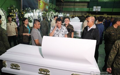 <p><strong>A SALUTE TO SLAIN SOLDIERS</strong>. President Rodrigo Duterte pays his last respects to six soldiers when he visited their wake at Camp General Vicente Lukban in Catbalogan City, Samar on Friday (Nov. 15, 2019). The soldiers died in an ambush by members of the New People’s Army on Monday (Nov. 11, 2019). With him are Senator Christopher Lawrence “Bong” Go (behind Duterte) and Defense Secretary Delfin Lorenzana (right, foreground). <em>(Presidential photo by Albert Alcain)</em></p>