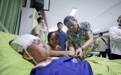 <p><strong>WORKING PRESIDENT.</strong> President Rodrigo Roa Duterte confers the Order of Lapu-Lapu Rank of Kampilan on one of the wounded law enforcers he visited at the Divine Word Hospital in Tacloban City Friday (Nov. 15, 2019). The 74-year-old Duterte, in a television interview on Monday (Nov. 18), admitted that age is taking a toll on his health. <em>(Presidential photo of Ace Morandante)</em></p>