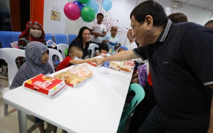 <p><strong>CHRISTMAS TRADITION</strong>. President Rodrigo Duterte does a fist bump with a patient of the Southern Philippines Medical Center's (SPMC) Cancer Institute - Children's Unit in Davao City on Dec. 23, 2018. It has been Duterte’s Christmas tradition to visit SPMC to give gifts to young cancer patients every year. (<em>Presidential photo by Toto Lozano)</em></p>