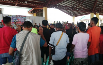 <p><strong>REBEL-RETURNEES</strong>. Some 26 former members and supporters of the CPPA-NPA formally pledge allegiance to the national government during a turn-over ceremony at Mabini, Pangasinan on Wednesday (Nov. 20, 2019).  During the event organized by the Pangasinan Police Provincial Office, they received farm equipment/ machineries and other government services from different government agencies. <em>(Photo by Hilda Austria)</em></p>